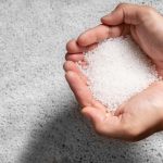 engineer hold white plastic on hand polymer petrochemical product as polymer raw material for plastic in polymer chemical industry design and test in polymer science laboratory